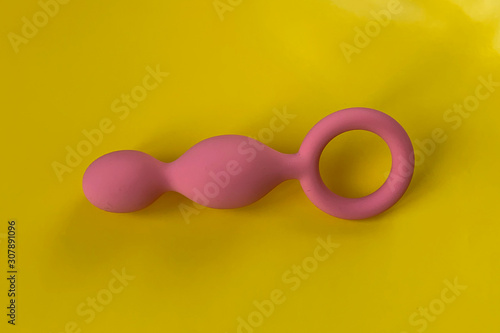 Anal plug for sex. Sex toys. On yellow background. Useful for sex shop