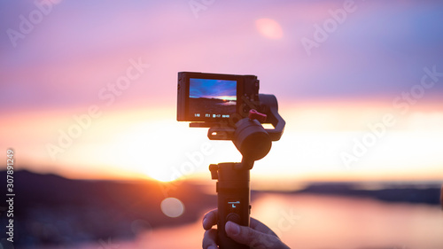 Camera on stabilizer is recording beautiful view at twilight photo