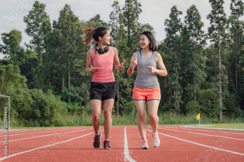 Sporty asian woman runner in fashionable sportswear