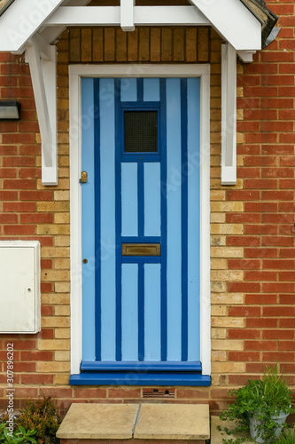 Front door painted in light and dark blue stripes