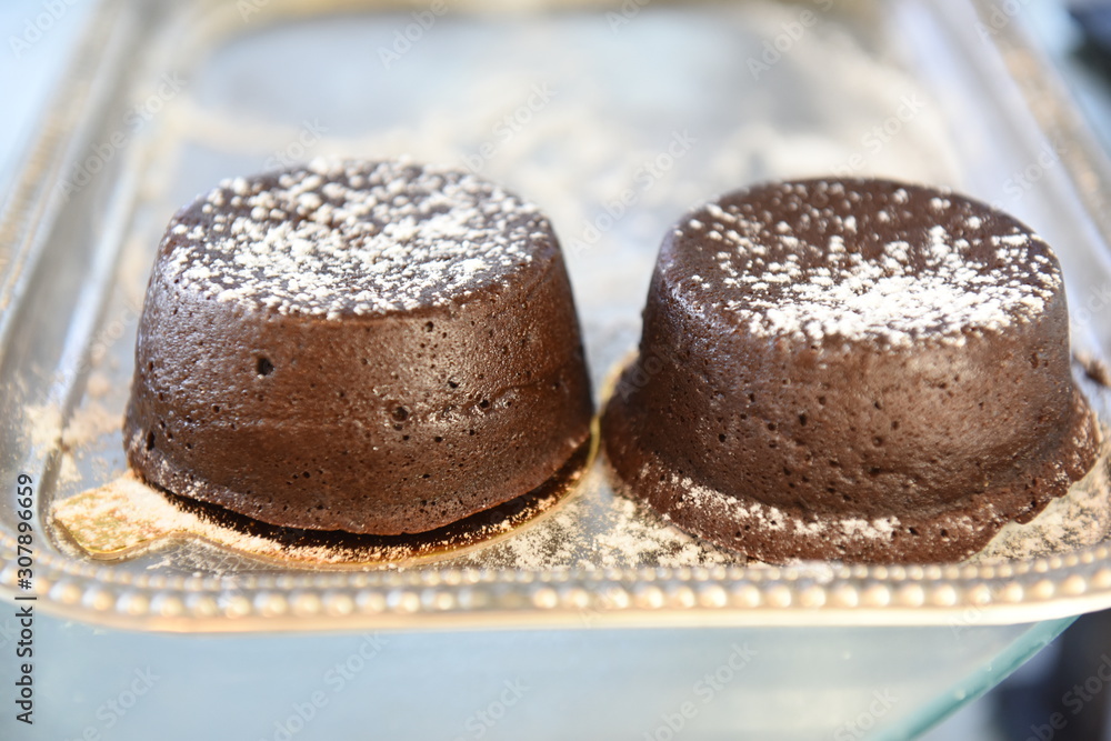 Individual chocolate lava cake dusted with powdered sugar Individual chocolate lava cake dusted with powdered sugar