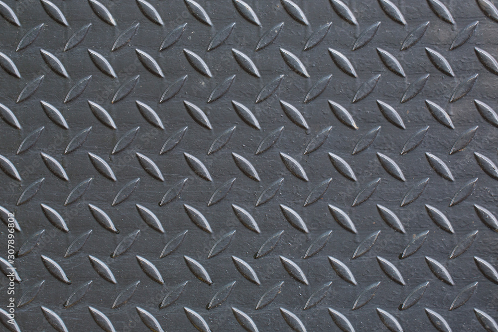 Industrial wallpaper of functional anti-slip metal tread plate in grey silver color and rough raised surface pattern. Creative lighting macro photography of construction for catwalks, stairs, walkway. Industrial wallpaper of functional anti-slip metal tread plate in grey silver color and rough raised surface pattern. Creative lighting macro photography of construction for catwalks, stairs, walkway.