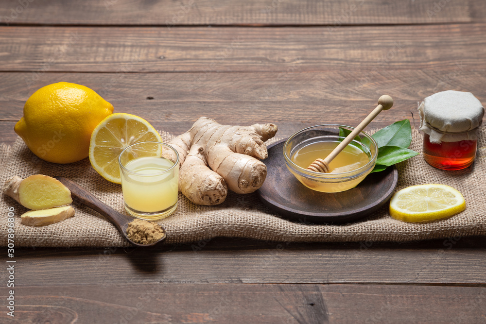 Ginger, honey and lemon, .on wooden base. Natutal food and brevage concept. Ginger, honey and lemon, .on wooden base. Natutal food and brevage concept.