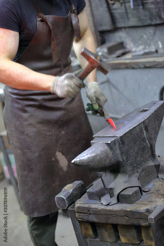 Forging an iron handmade product in a craft forge workshop Forging an iron handmade product in a craft forge workshop
