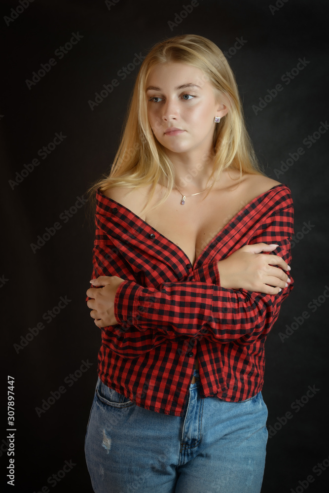 Portrait of beautiful woman with blue eyes in black-red shirt. Portrait of beautiful woman with blue eyes in black-red shirt.