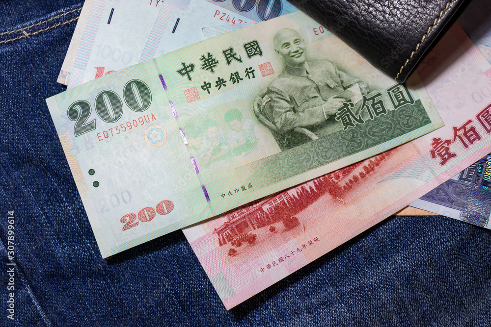 Obraz premium Taiwanese money, Taiwan Banknote, Taiwan dollar on jean background.