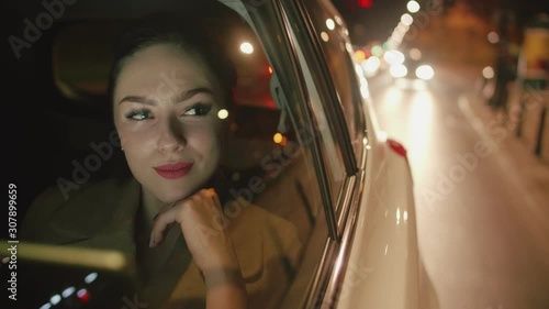 Young brunette Businesswoman in the taxi is reading messages on her tablet