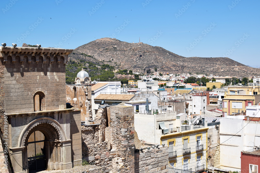 View of Cartagena city and mountains, Spain. Part of the ruins of roman amphitheater and cityscape of Cartagena, Spain