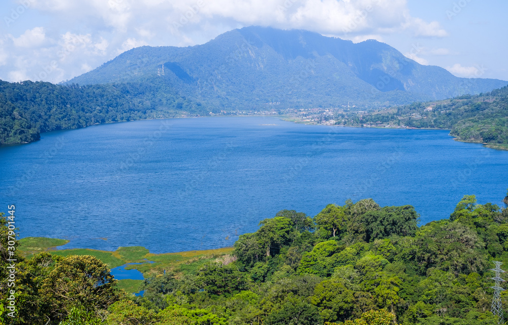 View of lake Buyan (Danau Buyan) from the top. Landscape with lake and mountain views. Bedugul, Buleleng, Bali, Indonesia. View of lake Buyan (Danau Buyan) from the top. Landscape with lake and mountain views. Bedugul, Buleleng, Bali, Indonesia.