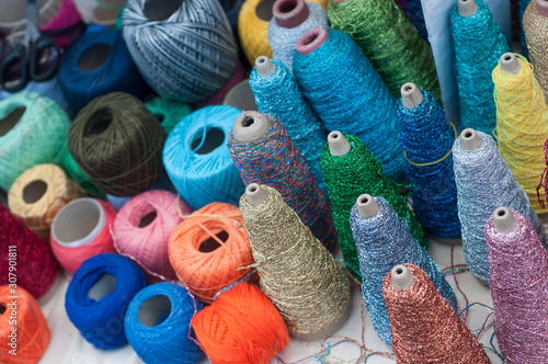 Closeup of colorful bobbins of various threads at the market