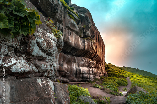 Rocky mountain landscape with green grass, with sunset. Lomas de Lucumo