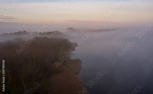 Ufer des Ruppiner Sees bei Wustrau im Nebelmeer zum Sonnenaufgang photo