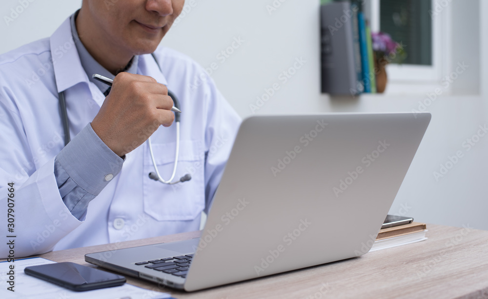 Doctor working on laptop computer