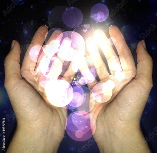 hands with magical violet balls