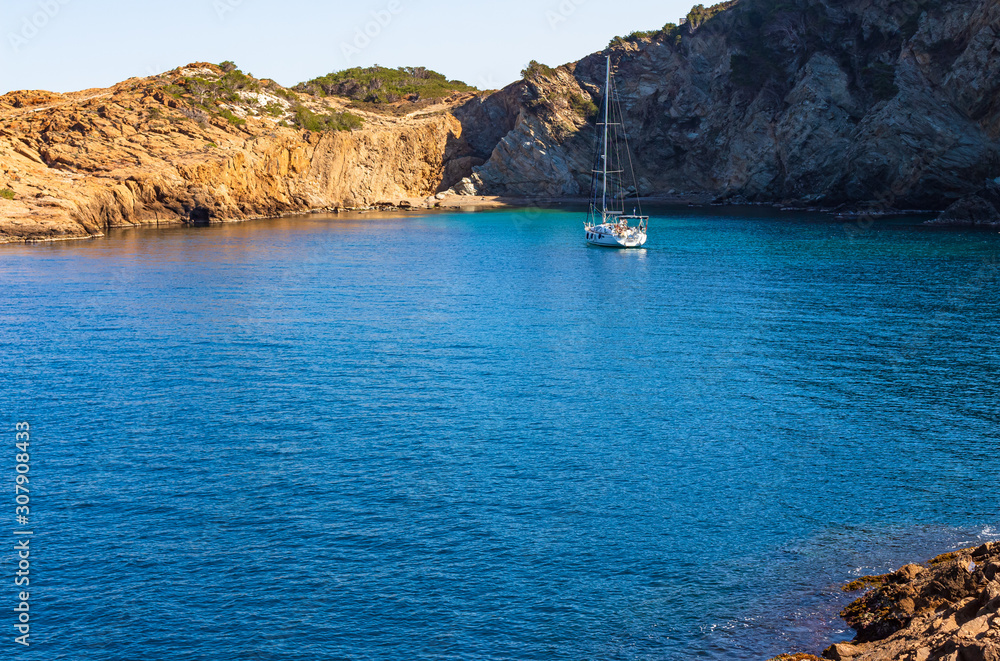 View of the bay of Sa Tuna with a anchored ship, Begur, Costa Brava, Catalonia, Spain