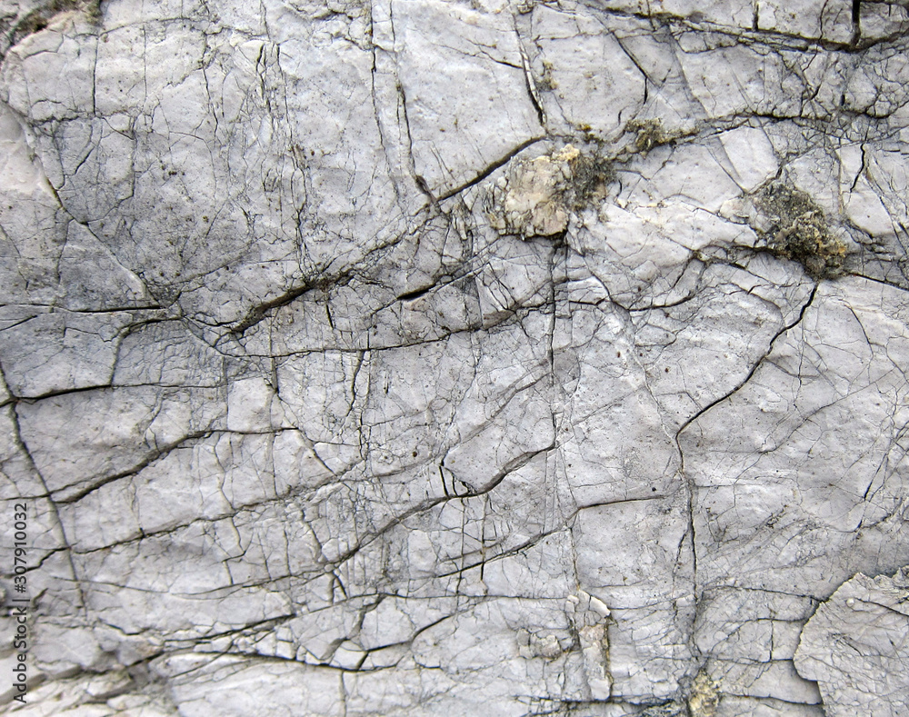Texture of a sedimentary limestone rock with cracks Texture of a sedimentary limestone rock with cracks