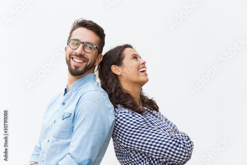Fototapeta Joyful carefree couple leaning on each other, chatting and laughing at joke