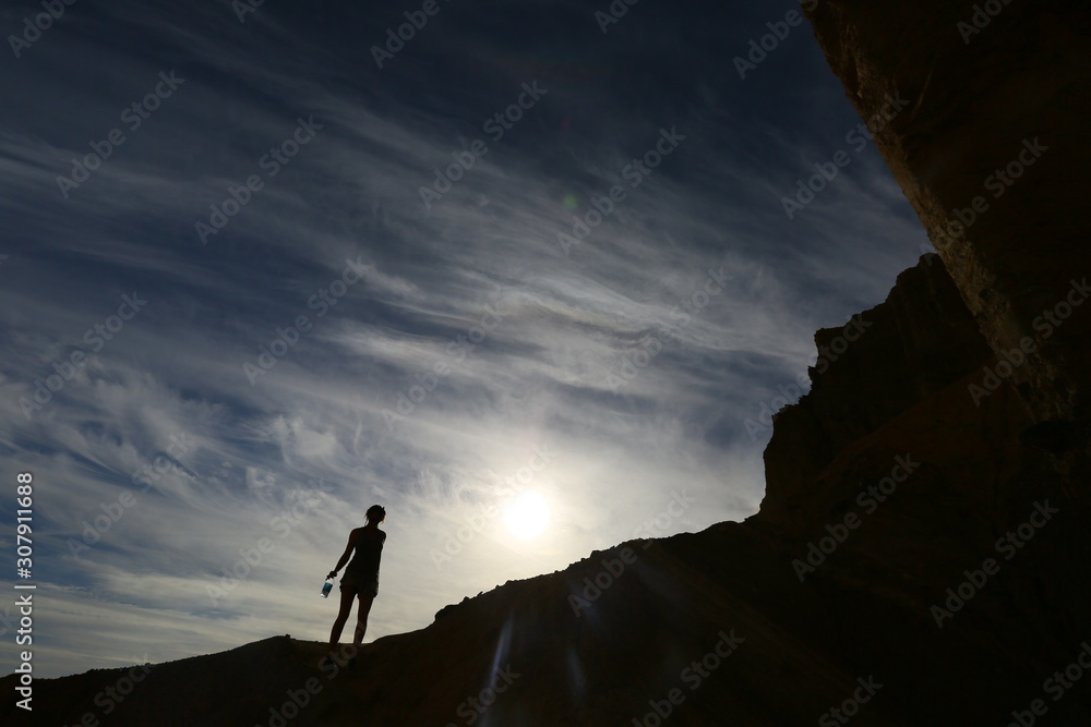 silhouette of man on top of mountain