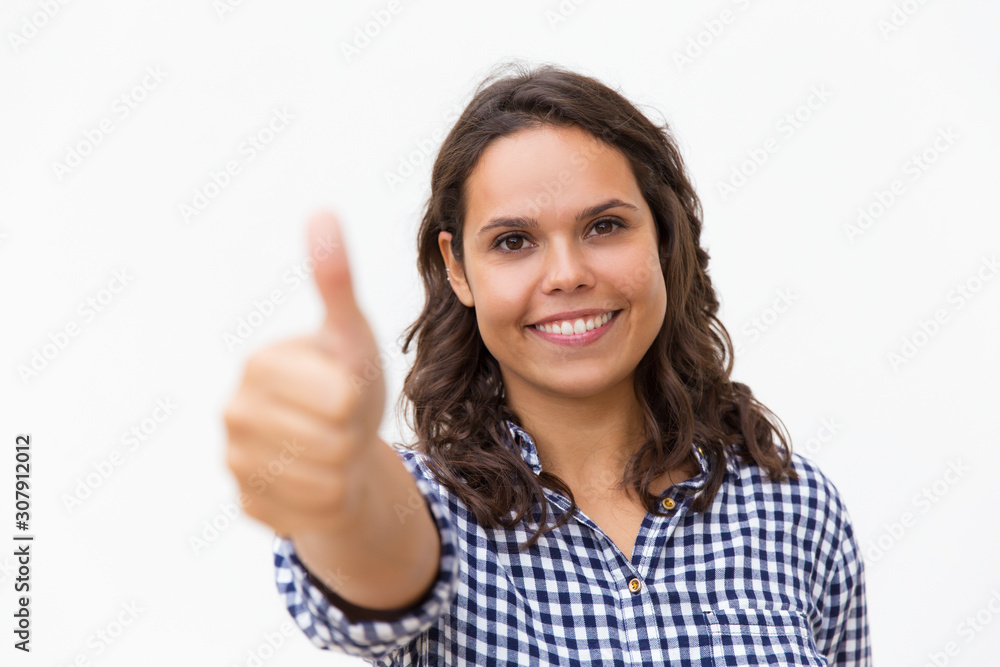 Happy female customer making Like gesture, looking at camera, smiling. Young woman in casual checked shirt standing isolated over white background. Positive feedback concept Happy female customer making Like gesture, looking at camera, smiling. Young woman in casual checked shirt standing isolated over white background. Positive feedback concept