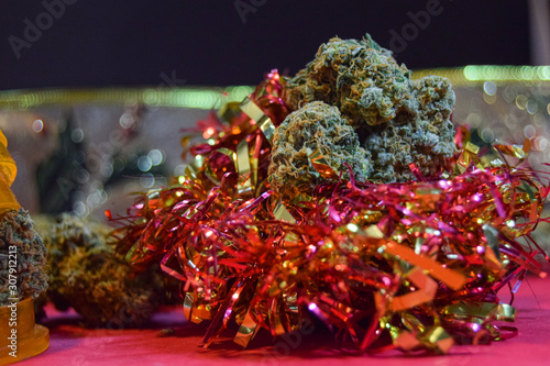 dried cannabis flowers with christmas decorations to celebrate the new year