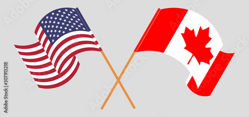 Crossed and waving flags of the USA and Canada