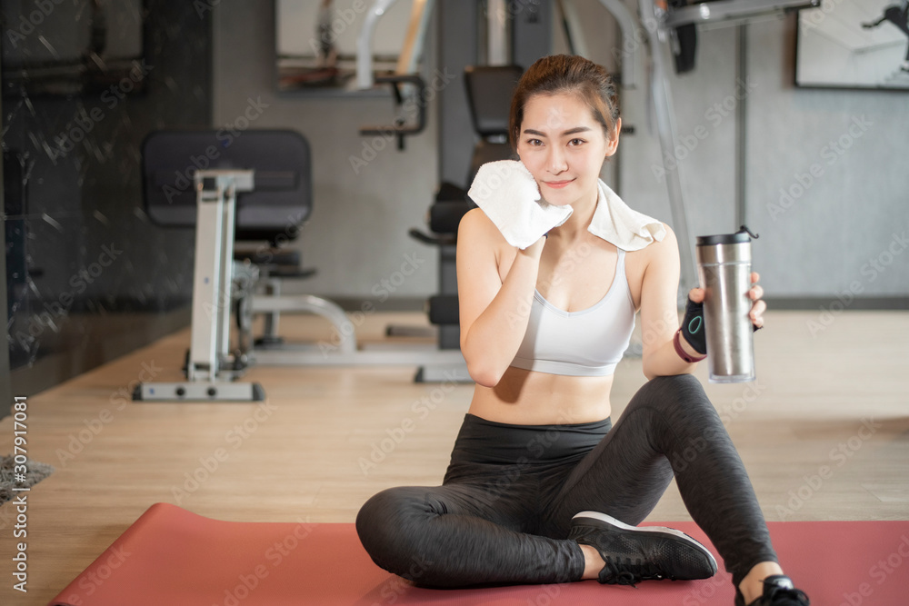 Beautiful asian woman is doing exercise in the gym Beautiful asian woman is doing exercise in the gym