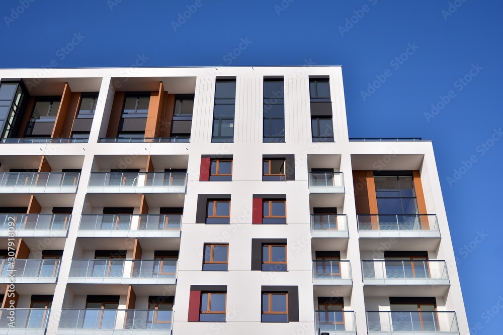 Modern apartment buildings on a sunny day with a blue sky. Facade of a modern apartment building. Glass surface with sunlight. Modern apartment buildings on a sunny day with a blue sky. Facade of a modern apartment building. Glass surface with sunlight.