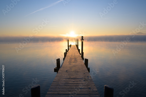 Steg am Chiemsee beim winterlichen Sommeraufgang photo