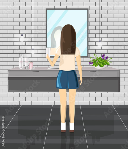 Girl using modern bathroom in the morning. Sink, mirror and various cosmetic ...