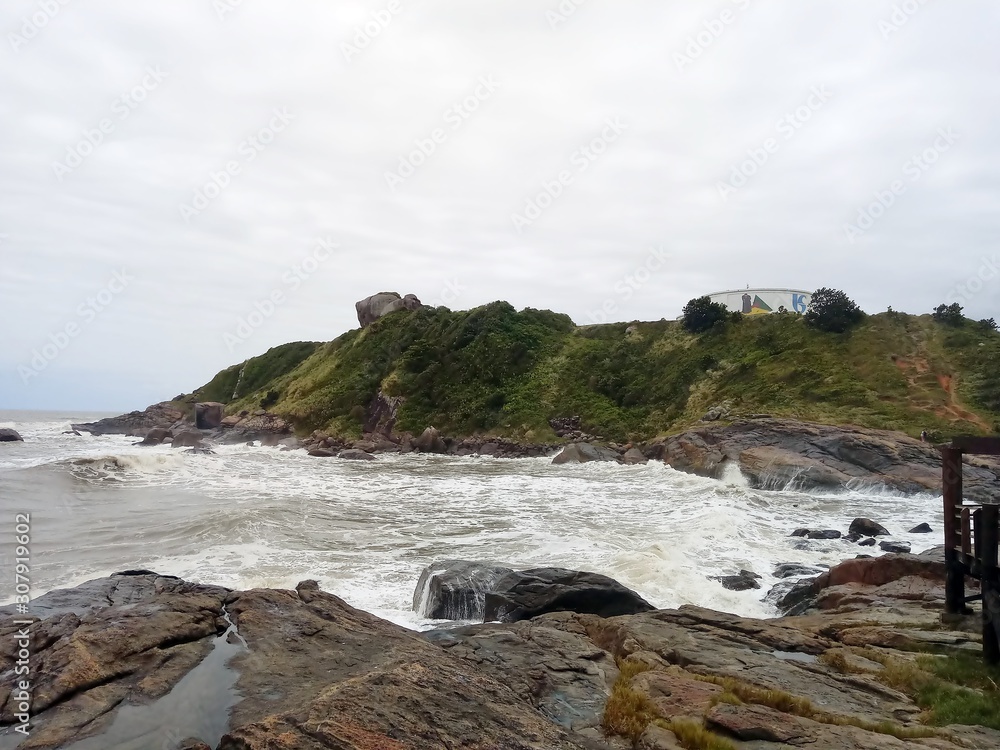 An small island with the sea near the shore and the rocks. An small island with the sea near the shore and the rocks.