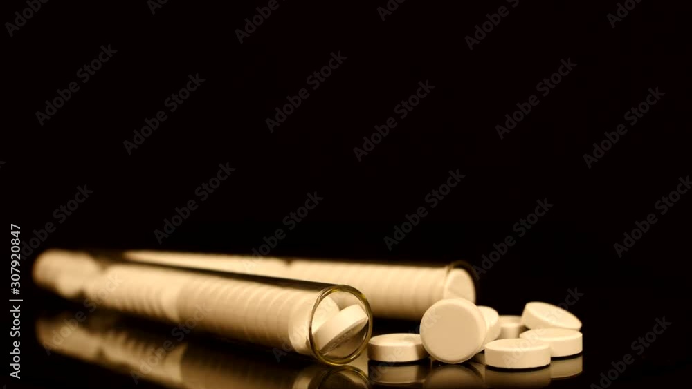 Generic drugs on table top, camera moves slowly accross spilled pills and into the bottle. Generic drugs on table top, camera moves slowly accross spilled pills and into the bottle.