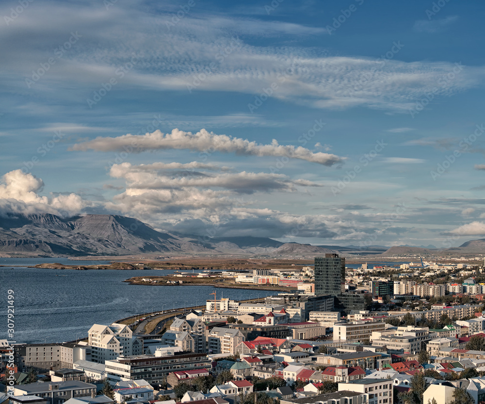 Obraz premium Beautiful wide angle aerial view Reykjavik Iceland cityscape and Faxafloi Bay with capital city skyline and sweeping high view of capital region, Reykjavik Harbour Harbor mountains and water.