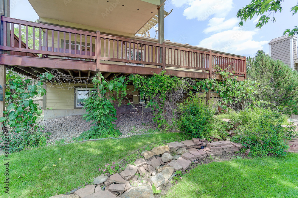 Landscaped sloping back yard with rock wall Landscaped sloping back yard with rock wall