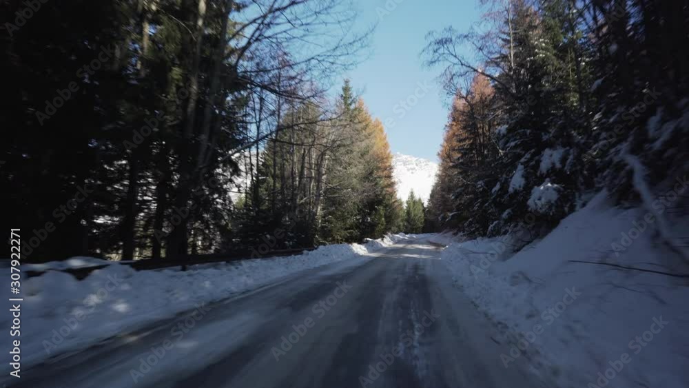 Driving on a frozen asphalt in the italian Alps while going to Bormio 2000 in Valtellina Driving on a frozen asphalt in the italian Alps while going to Bormio 2000 in Valtellina