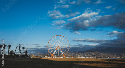 Ferris wheel in the city of Batumi at sunset day. Georgia