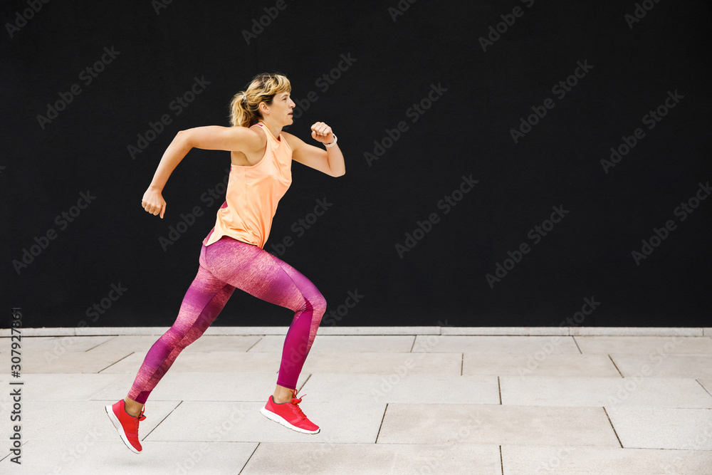 Young sporty woman dressed in sportswear doing her workout outdoors. Healthy Lifestyle