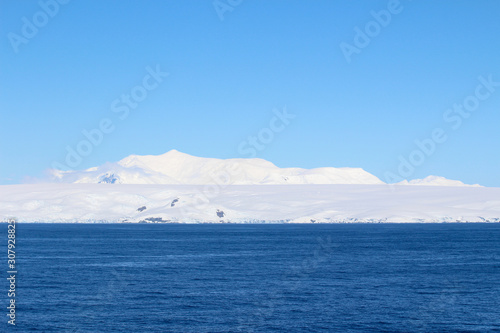 Snowy mountain on an island along the coasts of the Antarctic Peninsula, Antarctica © Marco Ramerini