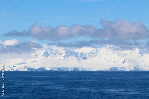 Snowy mountain on an island along the coasts of the Antarctic Peninsula, Antarctica