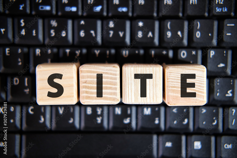 Text of the word SITE on wooden cubes on a black keyboard Text of the word SITE on wooden cubes on a black keyboard