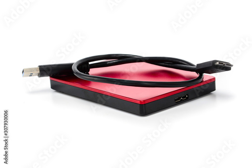 Red external hard drive disc with usb 3.0 cable. Best way of data storage on portable hdd. Close-up isolated on white surface.