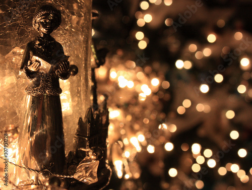 Christmas Caroler Ornament with White Lights in Background