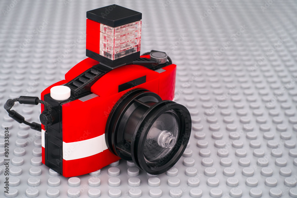 Lego camera on gray baseplate background. Photos