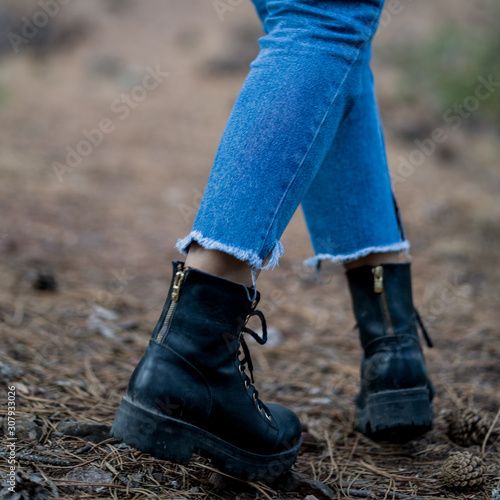 unisex black boots close-up photo in forest