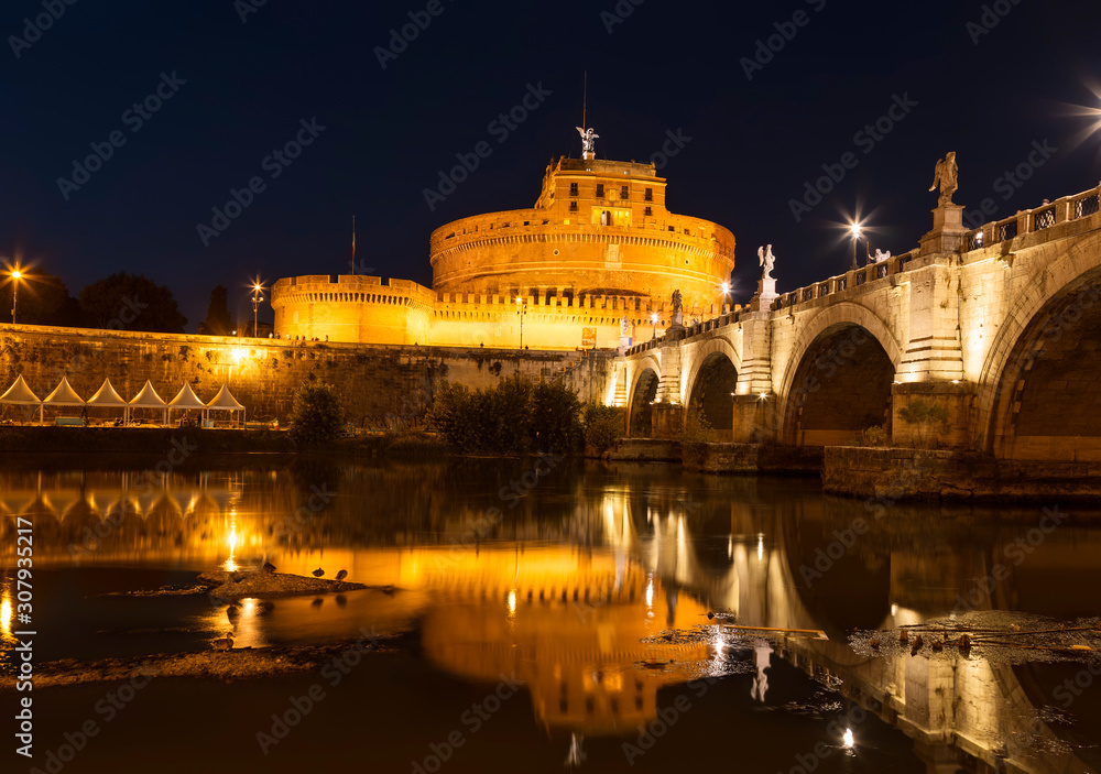 View of Castel Sant'angelo or Hadrian's Mausoleum and bridge of Sant'angelo at night. Rome, Italy