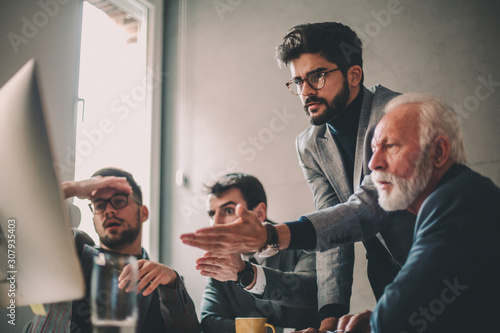 Fototapeta A team of executives facing an unexpeted hindrance on their way to achieve business goals
