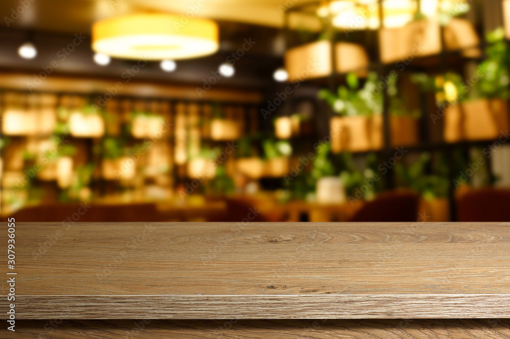 Empty table on blurred cafe interior background.