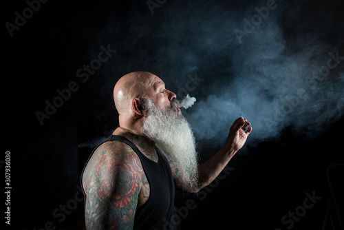older man with beard smoking © pat