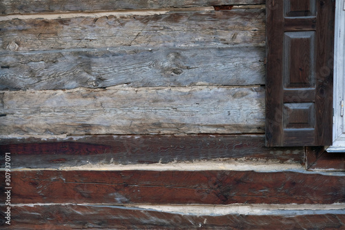 old weathered wooden of a rural cottage with a shutter. Plenty of copy space