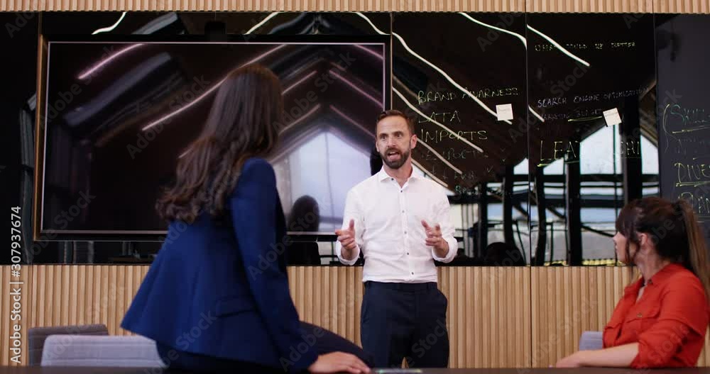 4K Business manager with aggressive attitude in a meeting with female colleagues. Slow motion. 4K Business manager with aggressive attitude in a meeting with female colleagues. Slow motion.