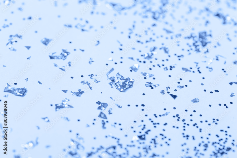 confetti and stars and sparkles on Classic Blue Christmas background. Top view, flat lay. Copyspace for text. Bright and festive holiday background. Color of year 2020. confetti and stars and sparkles on Classic Blue Christmas background. Top view, flat lay. Copyspace for text. Bright and festive holiday background. Color of year 2020.